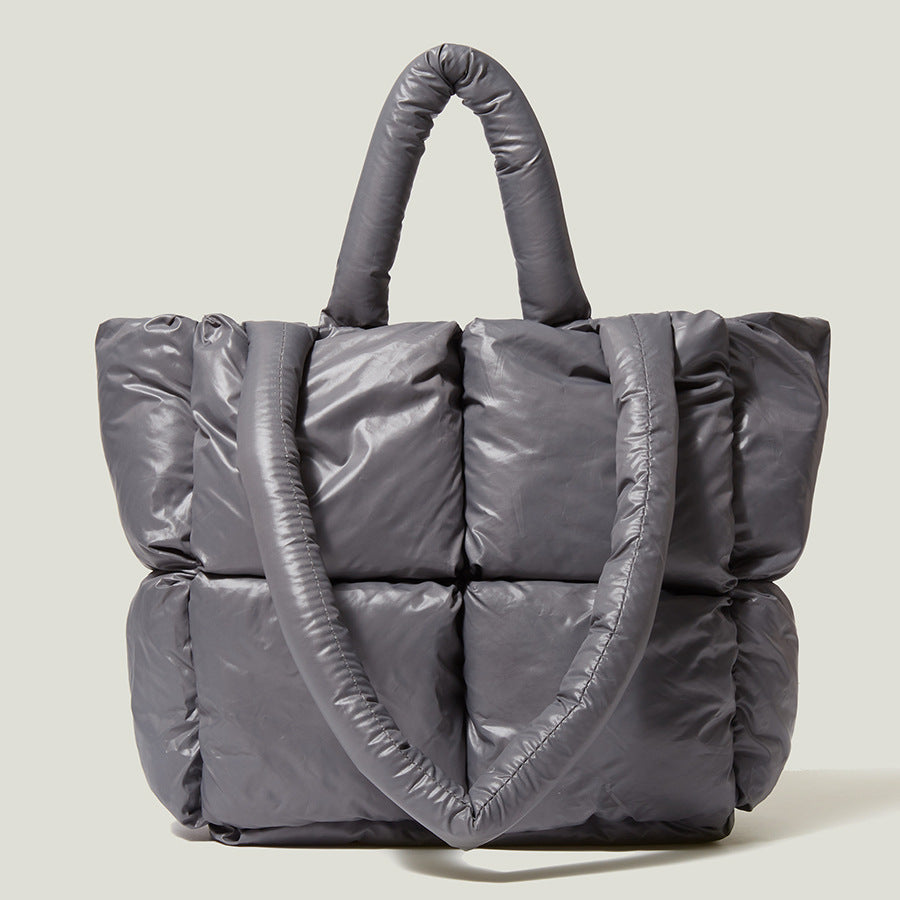 Gray puffer tote handbag with two top handles and quilted front panels