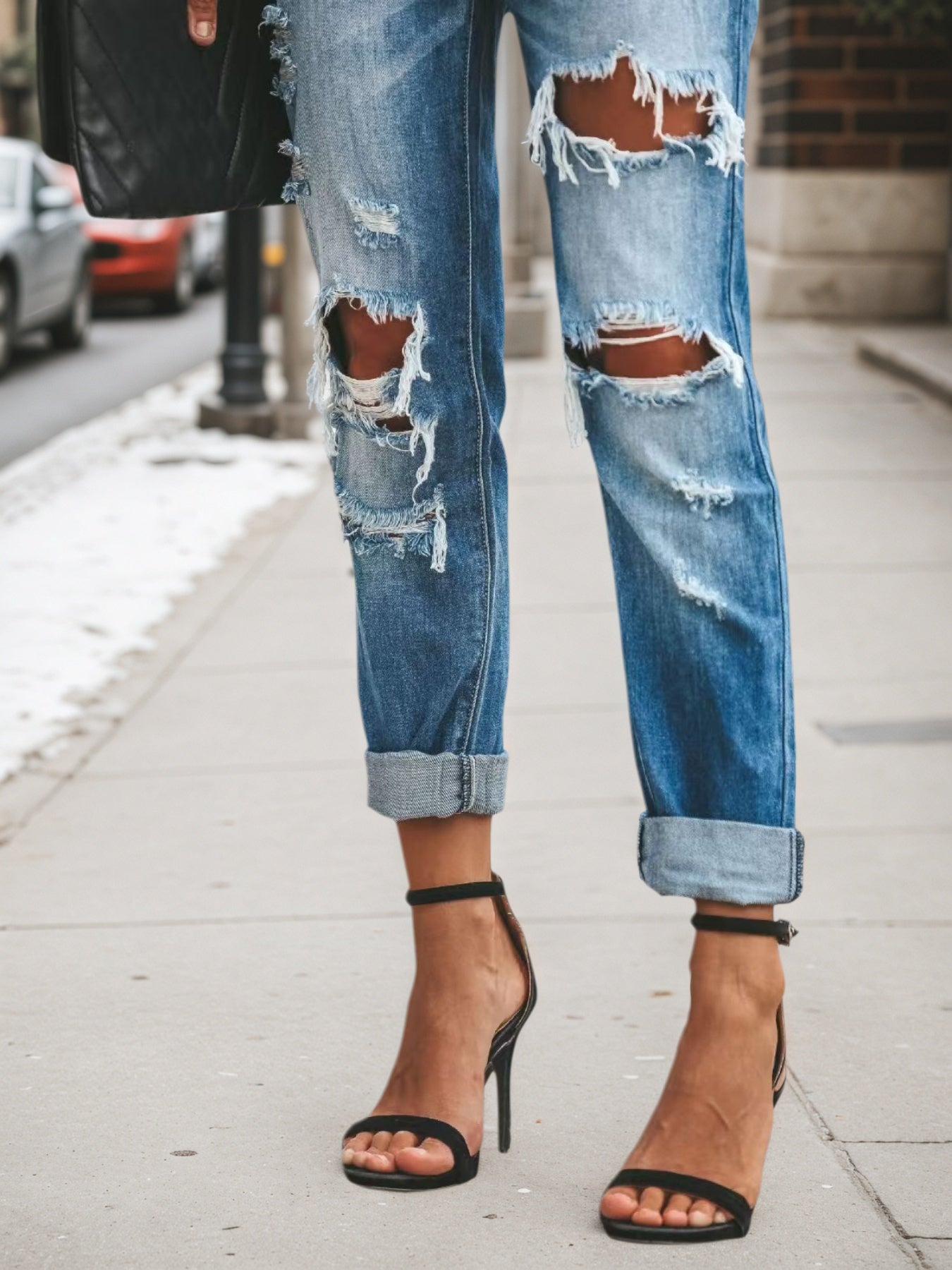 Light blue low-rise ripped jeans, front thigh rips and knee distress