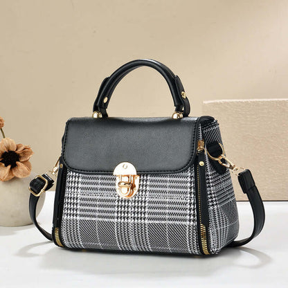 Black envelope shoulder tote with gray houndstooth body and gold clasp with straps