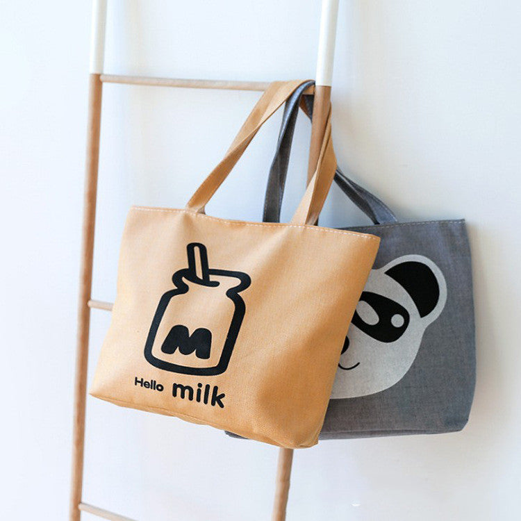 Canvas shoulder bags: tan “Hello milk” bag and gray bag with panda face