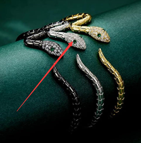 Snake bracelet set with black, silver, and gold-tone links and zircon eyes