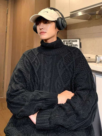 Black cable knit turtleneck sweater with diamond stitch pattern and ribbed cuffs
