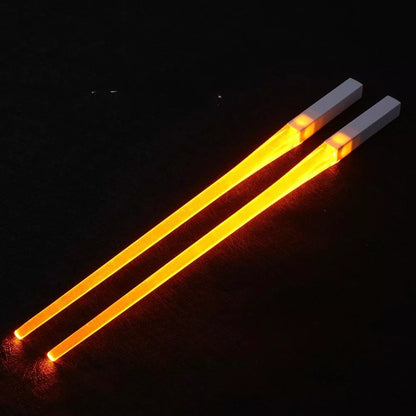 A reusable party utensil with nine colored fluorescent sticks and glowing chopsticks