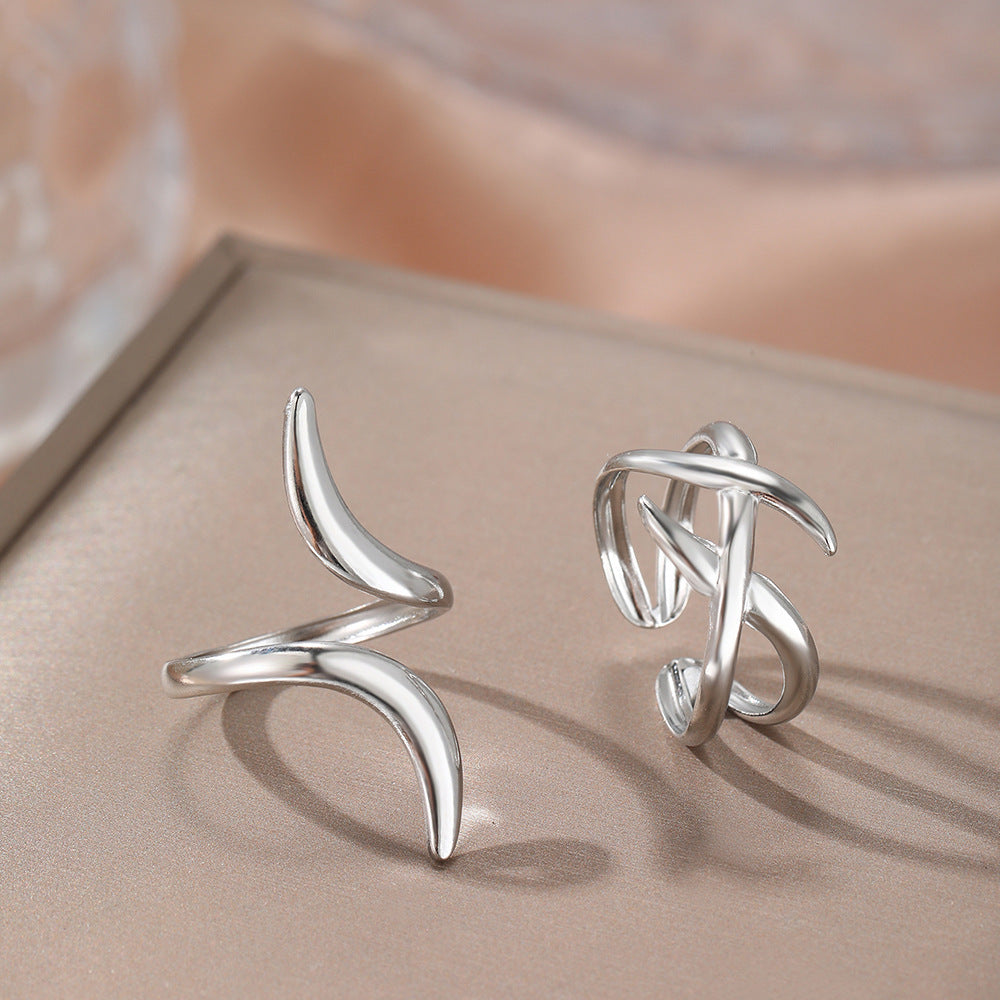 Silver geometric cross line rings with irregular curved openwork, shown pair