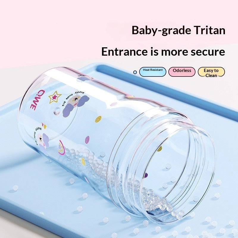 Clear kids drinking tumbler with blue straw and protective lid, water droplets visible