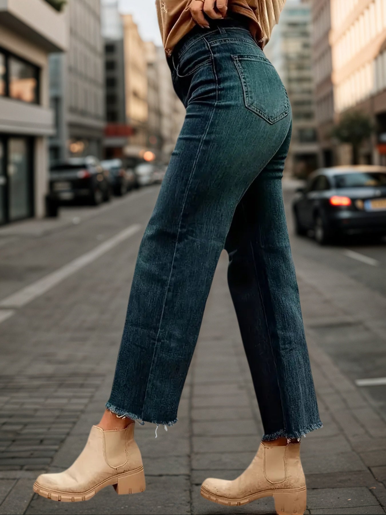 Wide-leg denim pants with cuffed hem, dark blue wash, stitched seams, five-pocket style.