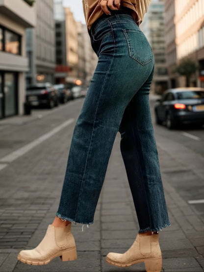 Wide-leg denim pants with cuffed hem, dark blue wash, stitched seams, five-pocket style.