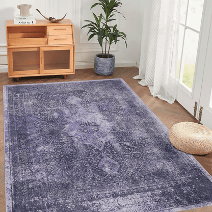 Anthracite washable area rug with distressed medallion pattern and low pile, corner view