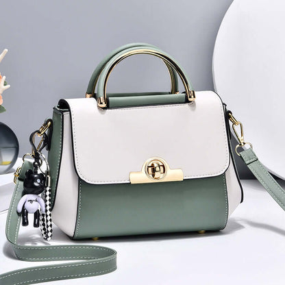Lightweight crossbody bag with white and green colorblock, top handle, flap, gold clasp