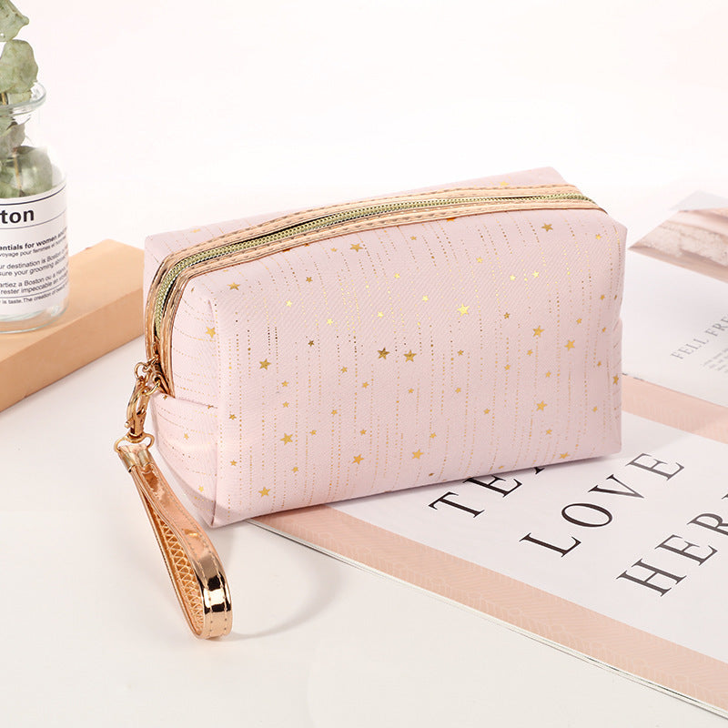Light pink octagonal star cosmetic bag with gold zipper and wrist strap