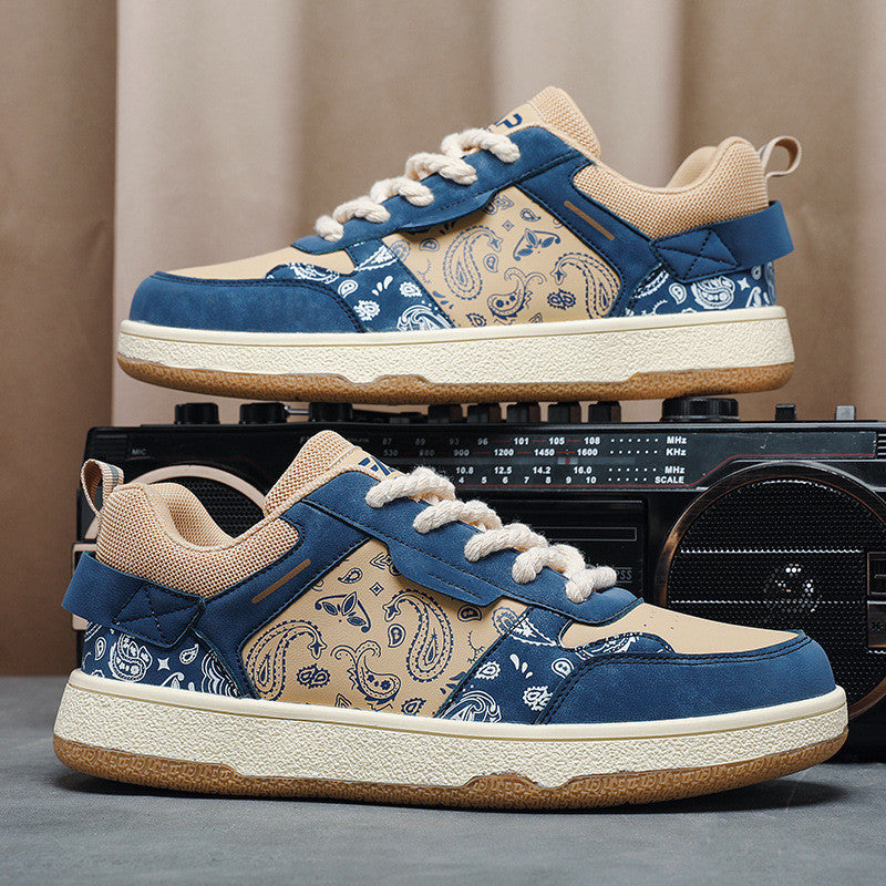 Low-top sneakers with blue canvas pattern, beige toe, and white lace-up detail