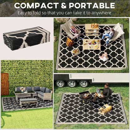 Reversible outdoor rug folded stack with black-and-cream quatrefoil pattern