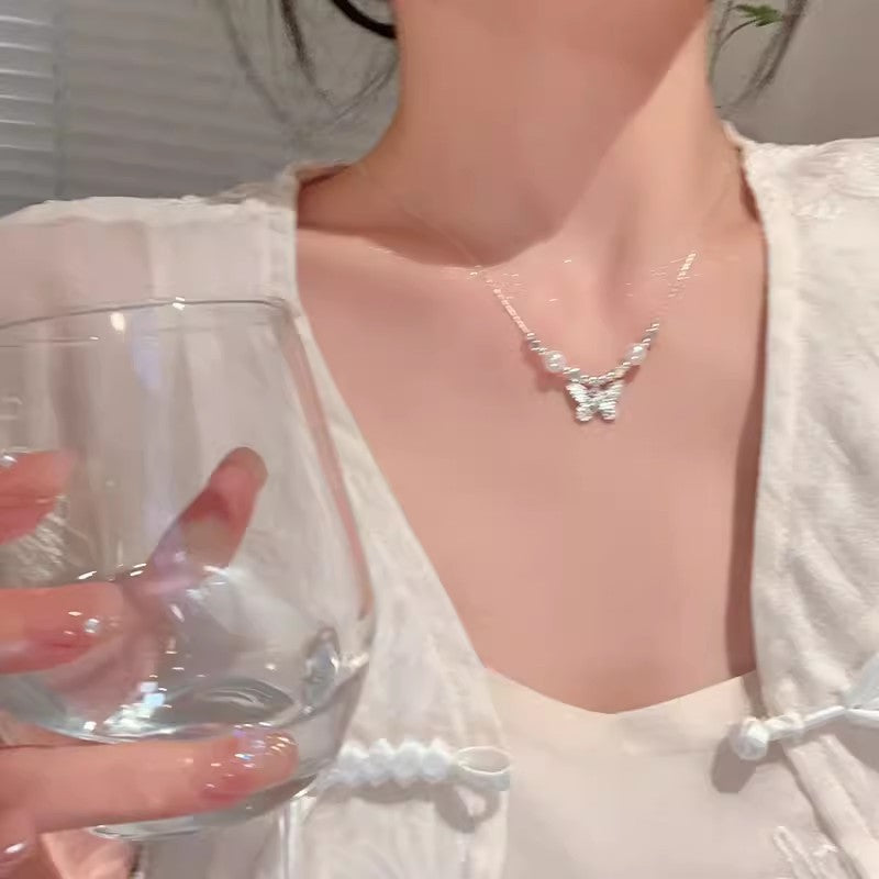 Pearl bow pendant necklace with delicate chain and small bow charm
