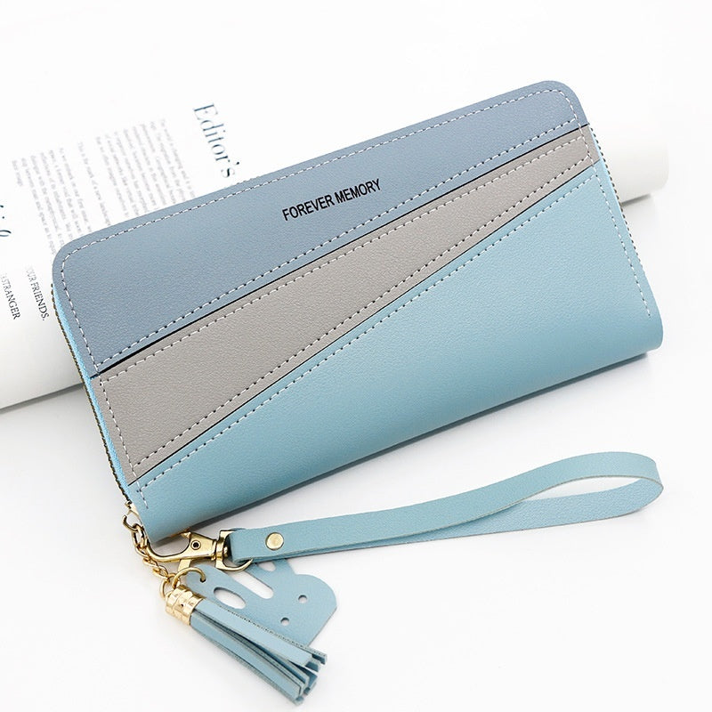 Long wallet with wrist strap, light blue and gray color blocks, tassel keychain.
