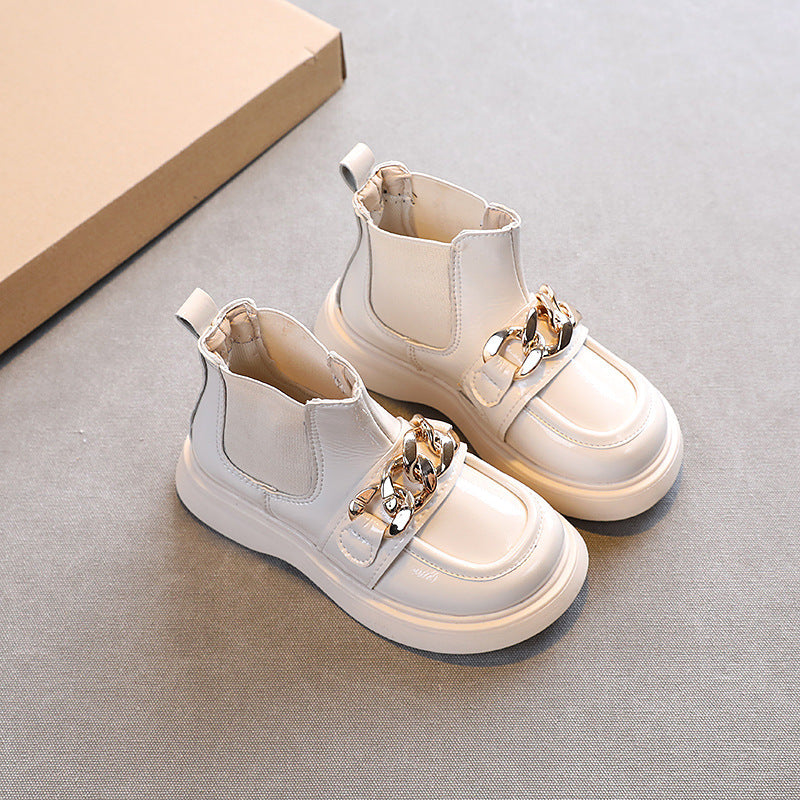 White patent ankle boots with gold chain strap and pull-on elastic panels