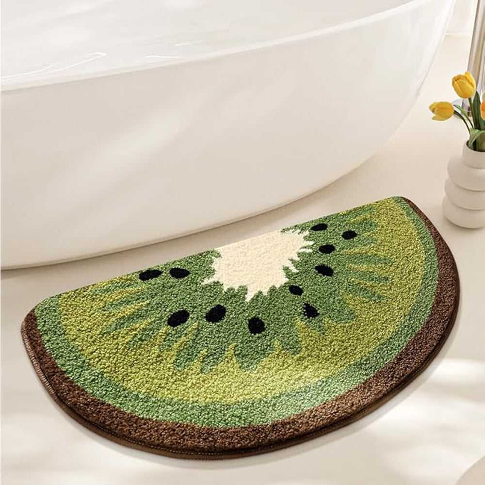 Green kiwi-shaped bath mat with brown border and black seed dots