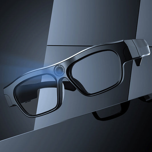 Black 3D glasses on a reflective surface with a dark background