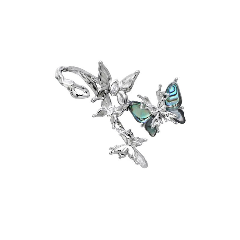 Silver butterfly stud earrings with blue-green oval accents and side floral charms