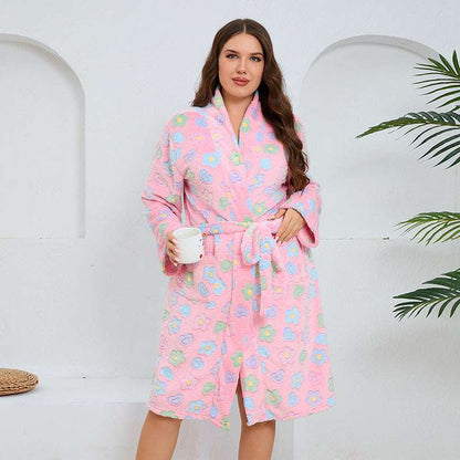 Woman wearing a pink floral robe holding a mug against a white background