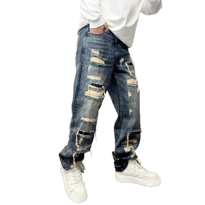 Men’s ripped patch jeans in light blue with wide leg and stitched distressed panels