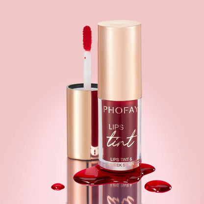 Lip tint bottle with doe-foot applicator and red droplets, rose-gold cap.