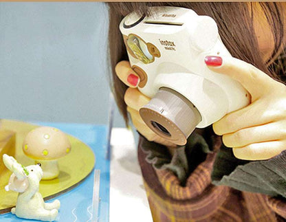 Person holding a white instant camera with a colorful background