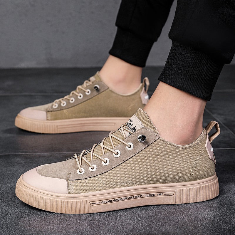 Khaki/beige low-top sneakers with tan sole, lace-up eyelets, side panel