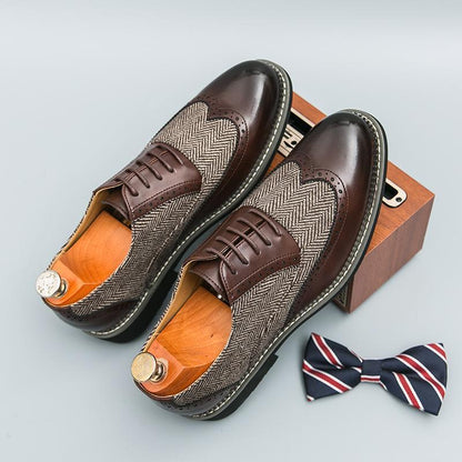 Brown dress shoes with herringbone pattern and wooden sole, accompanied by a bow tie on a light gray background.