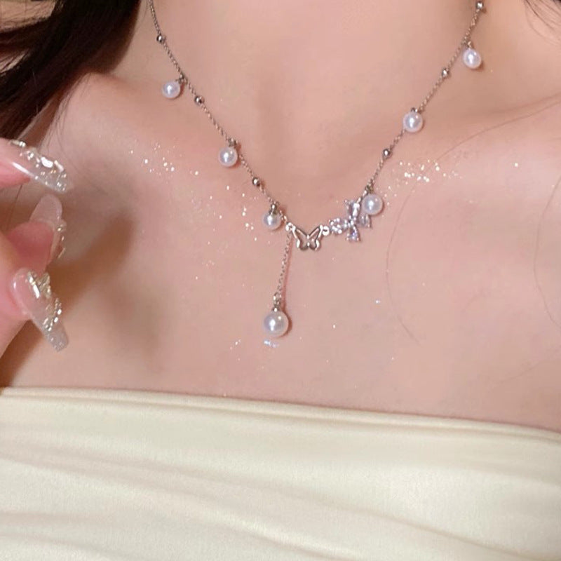 Butterfly pearl necklace with pearl drops and butterfly charm centerpiece