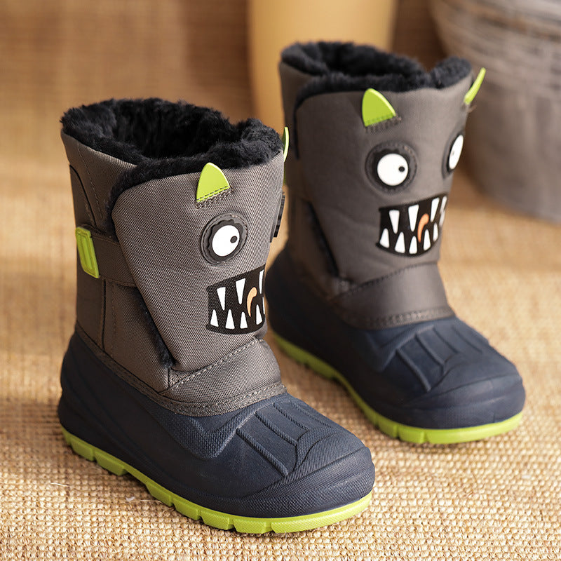Kids winter snow boots in dark gray/black with monster face graphic and green soles