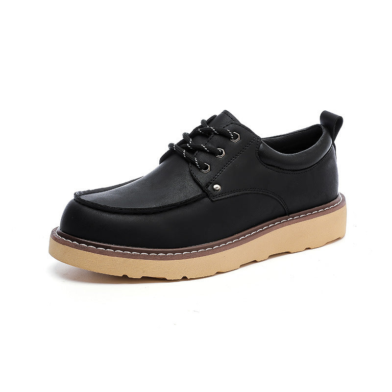 Black leather low-top work boots, lace-up with padded collar and tan lug sole
