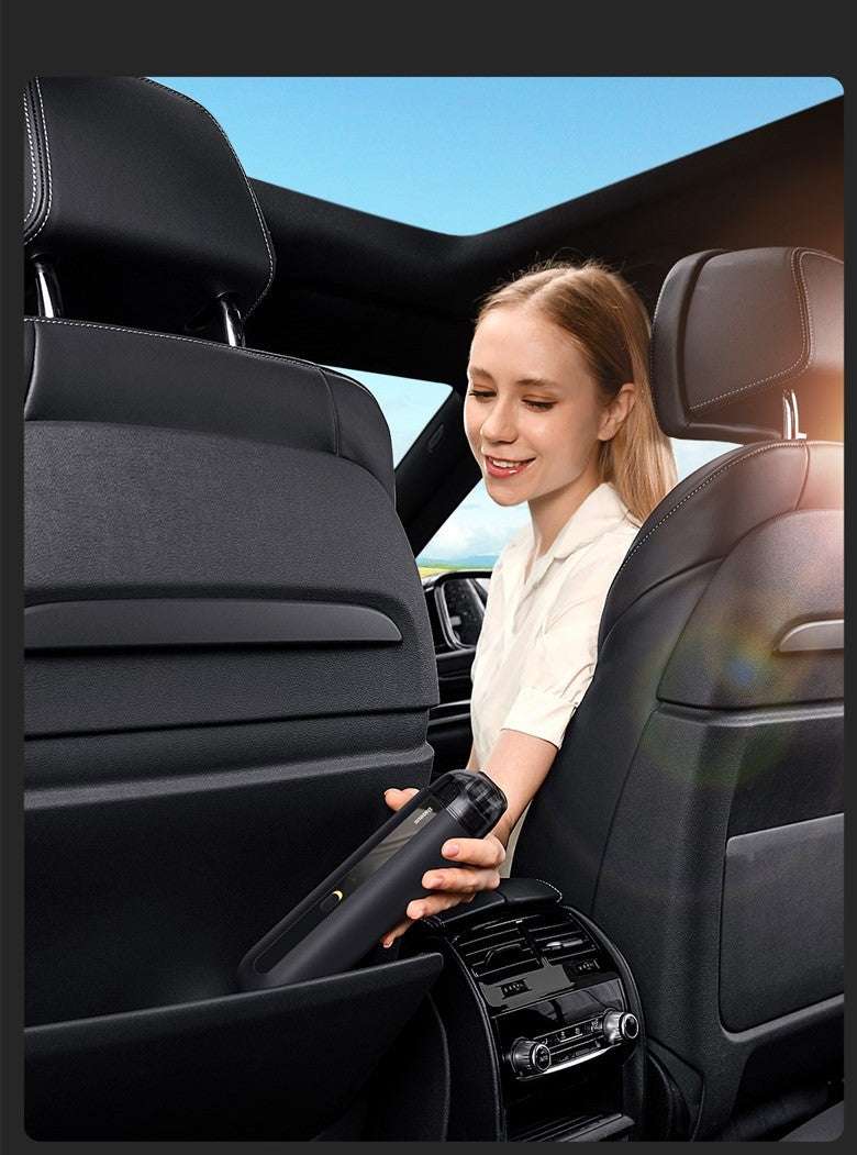 Woman cleaning car interior with a vacuum cleaner