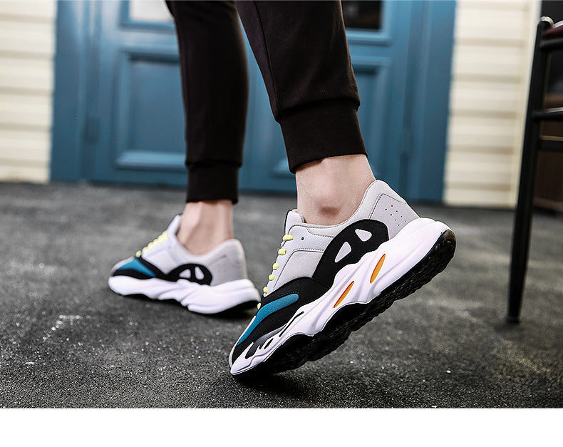 Light sneakers in white with black and blue accents, lace-up on feet
