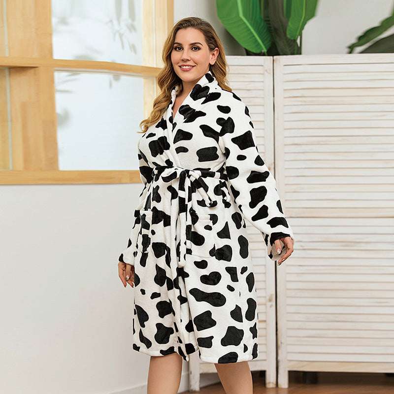 Woman wearing a black and white cow print robe indoors.