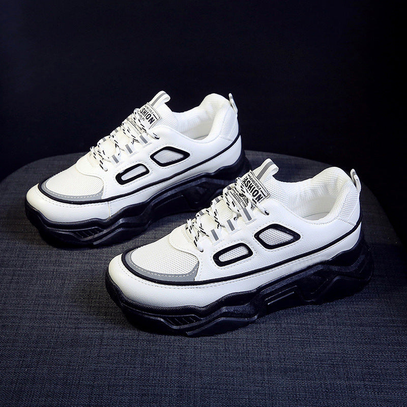 Platform sneakers, white upper with black paneling and oval side cutouts, lace-up