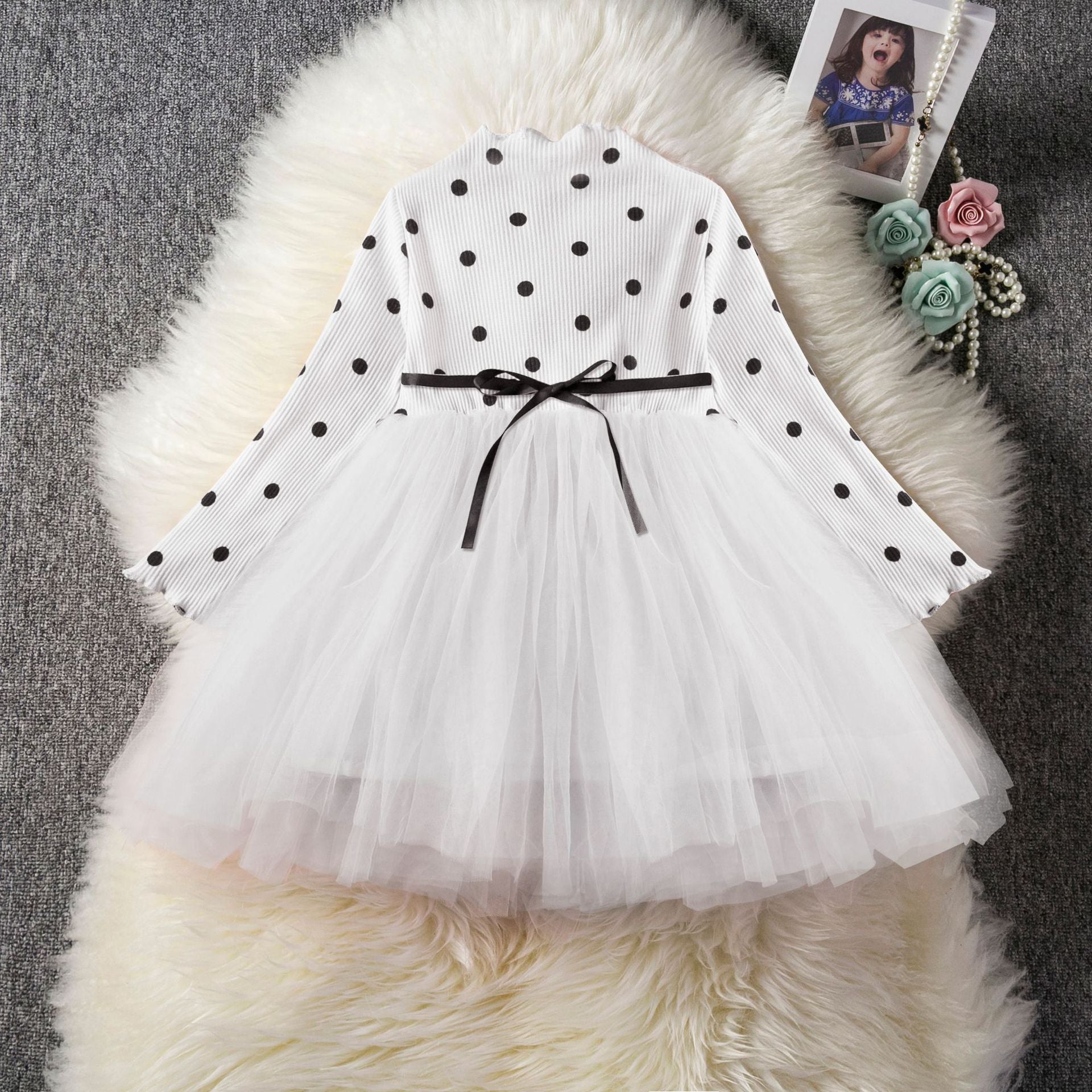 White polka-dot long-sleeve tutu dress with layered tulle skirt and black bow waist tie