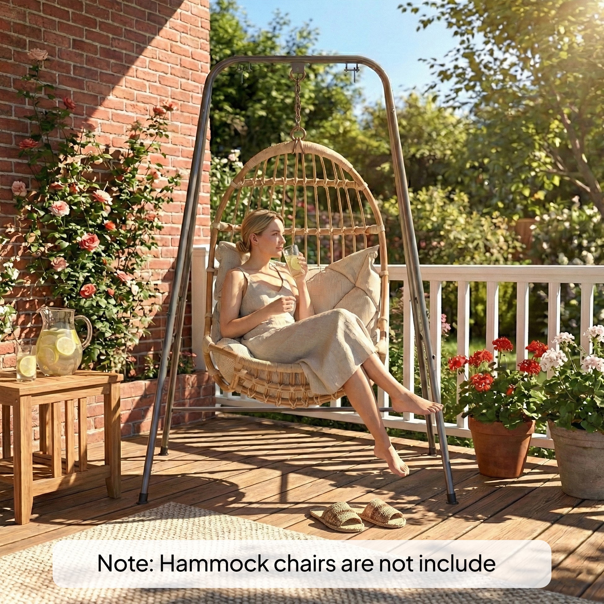 Gray hammock chair stand with hanging swing seat on a patio near a brick wall