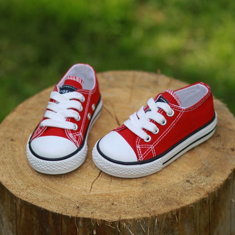 Non-slip canvas baby shoes pair in red with white laces and side stripe detail