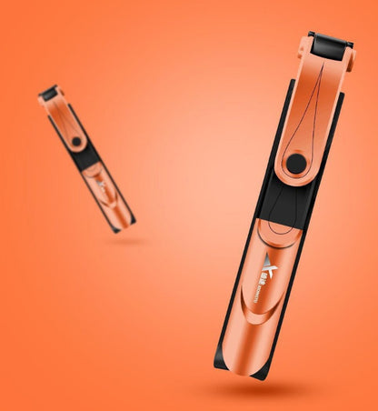 Copper-colored hair straightener on an orange background