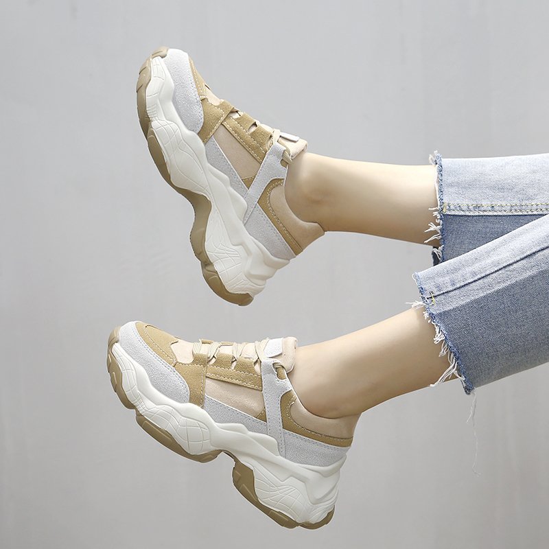 Women’s beige and white sneakers with lace-up straps and chunky textured sole