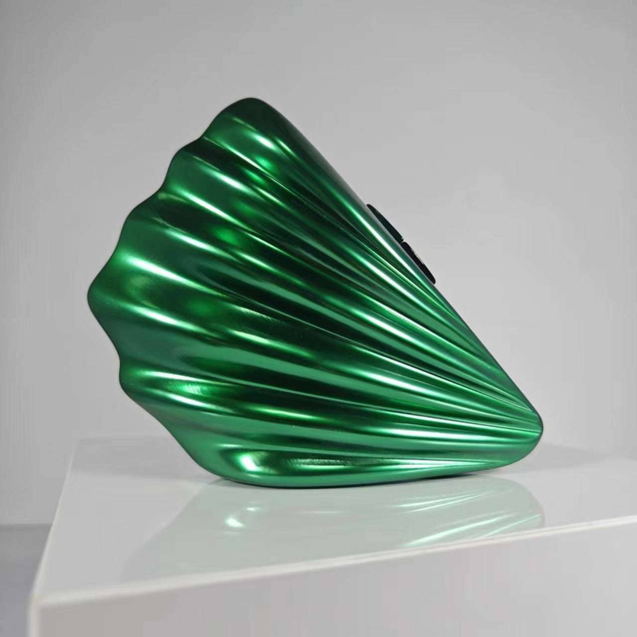 Metallic green shell crossbody bag with glossy curved ridges