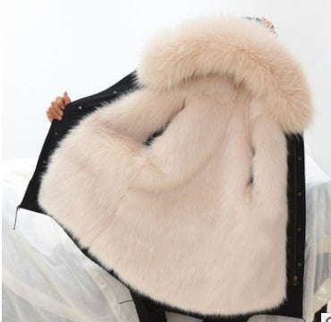 Close-up of a fur-lined garment with a fluffy hood on a white background