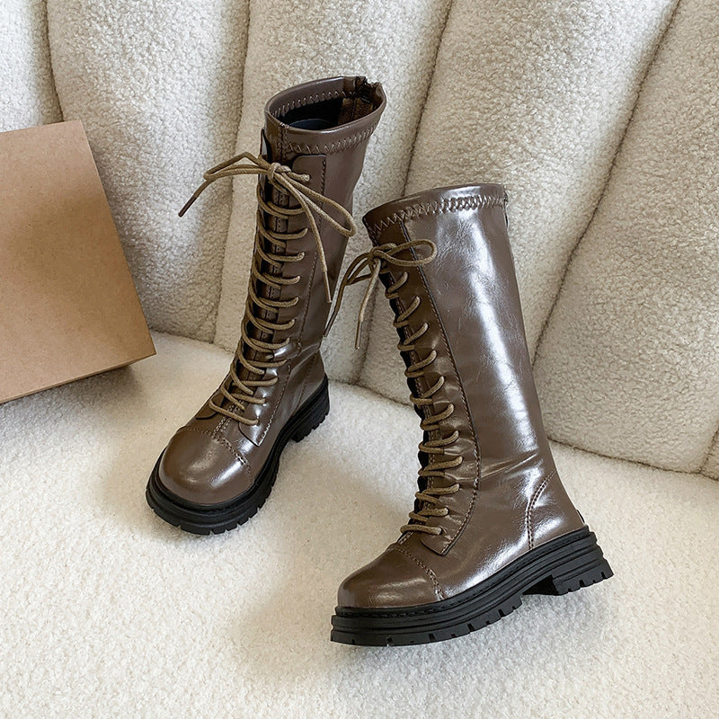 Girls' brown suede lace-up tall boots with chunky sole, shown as a pair