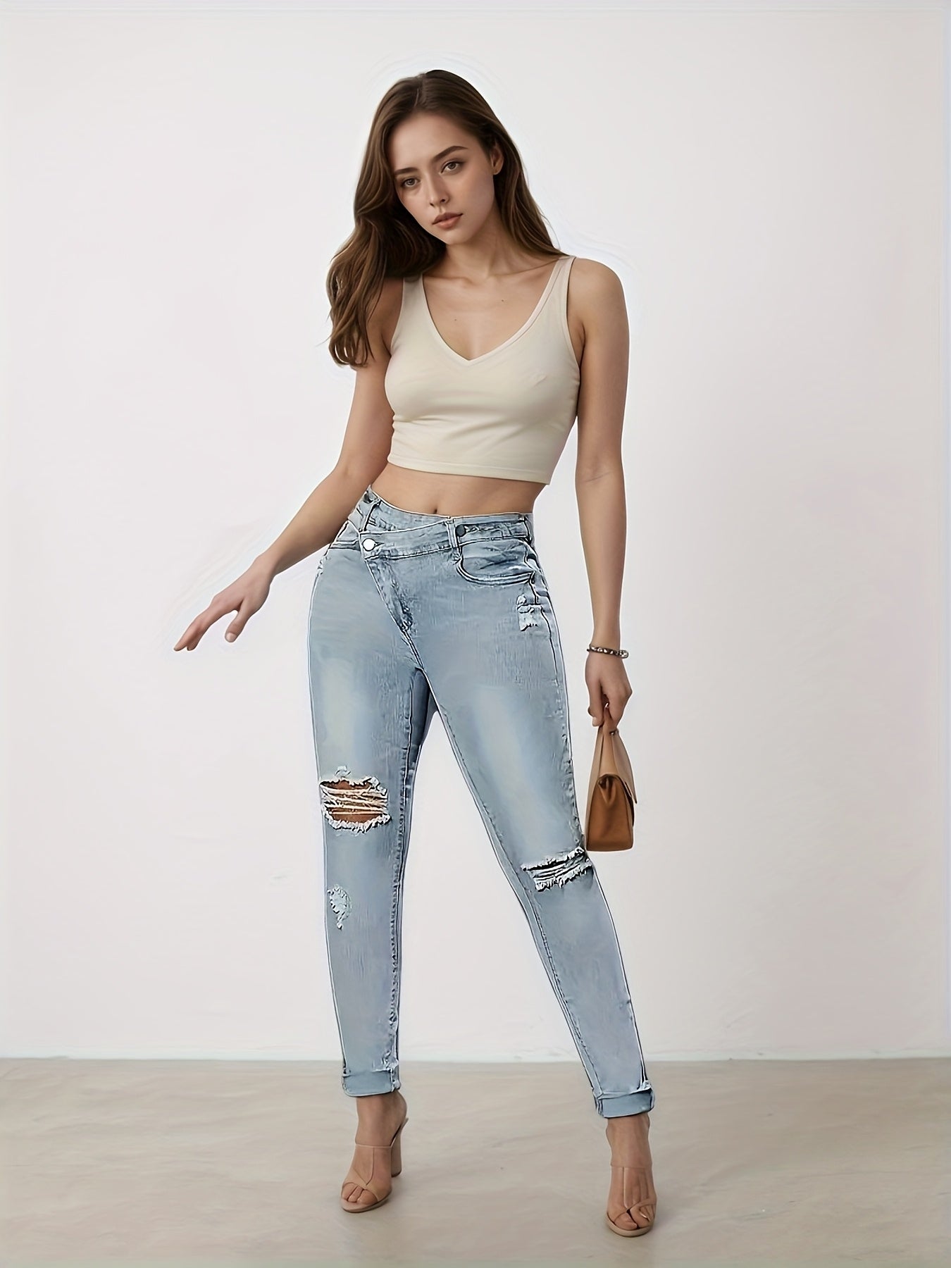 Light blue slim-fit denim leggings with multiple distressed rips and ankle length cuffs
