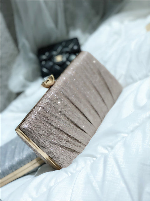 Silver-gray glitter clutch bag with gold-tone frame and beaded front panel