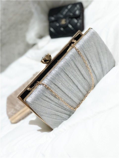 Light silver-blue glitter clutch bag with gold-tone frame and chain strap