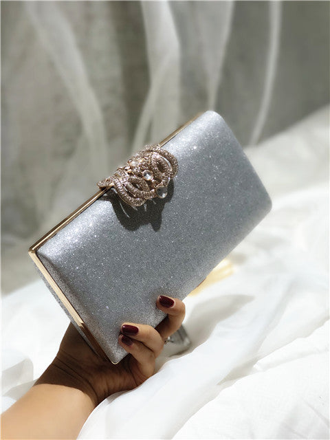 Sparkly silver clutch bag with gold-tone clasp