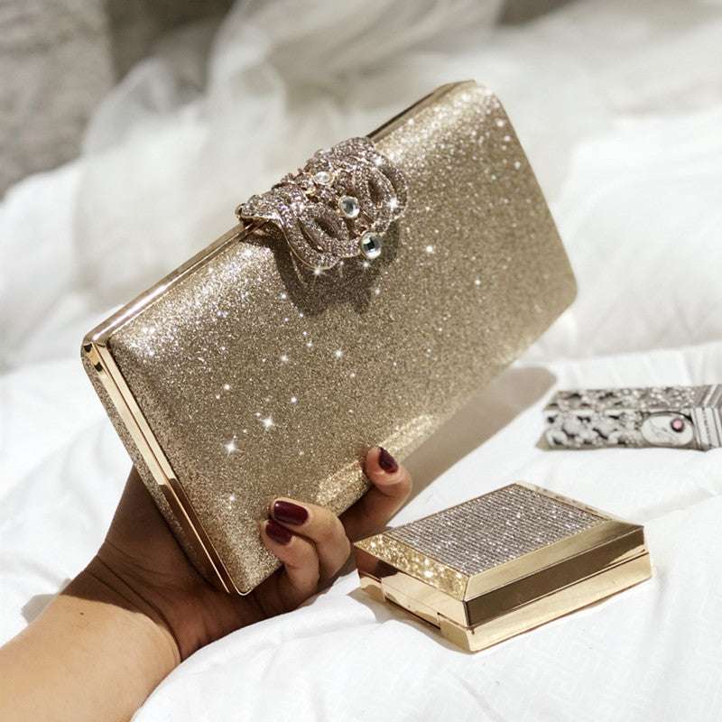 Champagne-gold glitter clutch bag with rhinestone butterfly clasp and gold frame