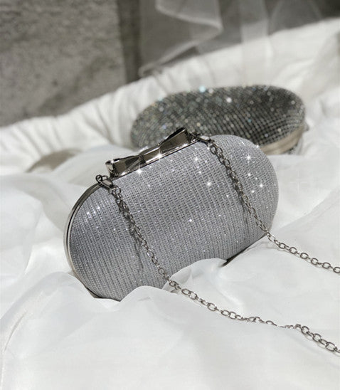 Silver-gray mesh oval clutch bag with hinged clasp and chain strap