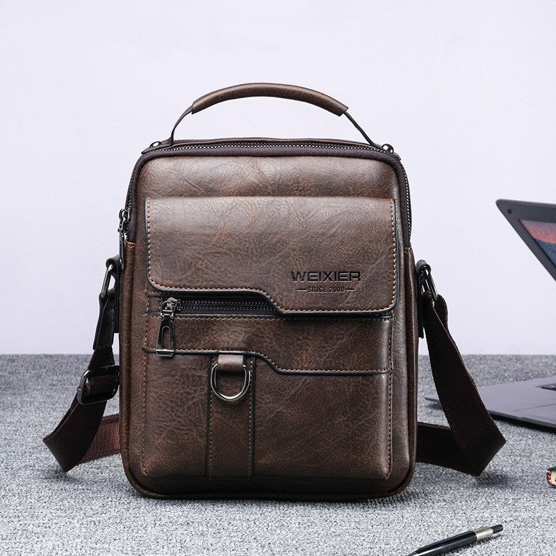 Dark brown vintage leather briefcase with front flap, zipper pocket, and crossbody strap